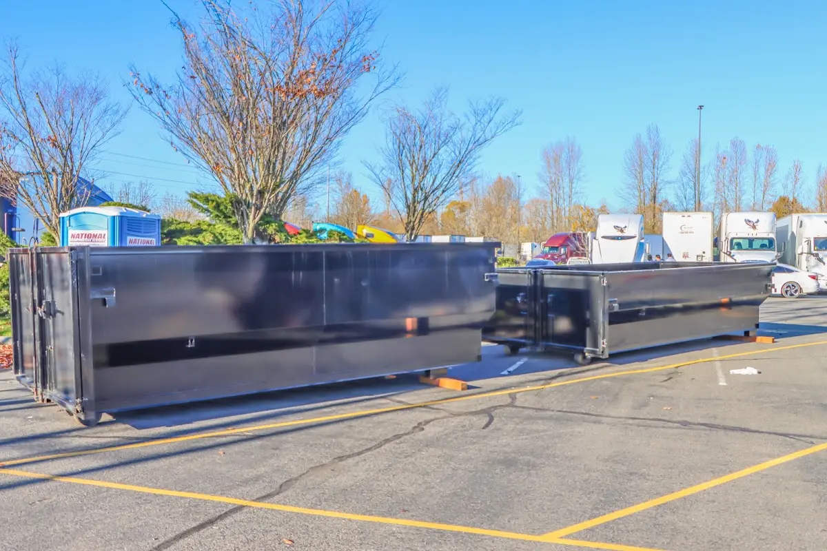 Professional dumpster rental service with roll-off container on residential driveway in Edgerton